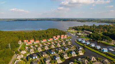 Luftaufnahme des Ferienparks Landal De Bloemert mit Ferienhäusern und viel Wasser