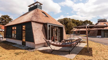 Garten mit Hängematte und Esstisch eines Ferienhauses im Ferienpark Dutchen Park Weideduyn