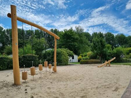 Wooden play equipment in a playground at the EuroParcs Molengroet holiday park