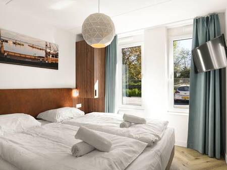 Schlafzimmer mit luxuriösem Doppelbett eines Ferienhauses im Ferienpark Landal Waterpark Volendam