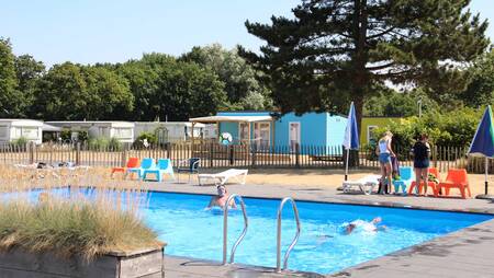 Menschen schwimmen im Außenpool des Ferienparks Molecaten Waterbos