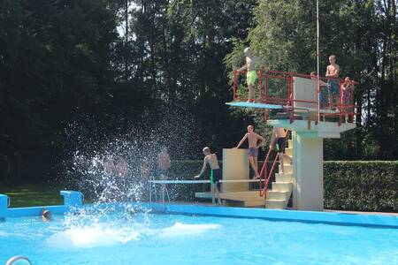 Menschen auf dem Sprungbrett im Freibad des Ferienparks Roompot Hunzepark