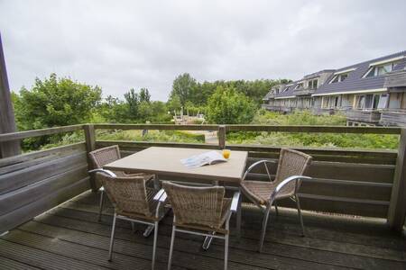 Tisch mit Stühlen auf dem Balkon einer Wohnung in der Résidence Terschelling