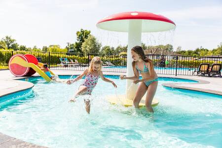 Zwei Kinder spielen im Planschbecken im Freien des Ferienparks Topparken Parc de IJsselhoeve