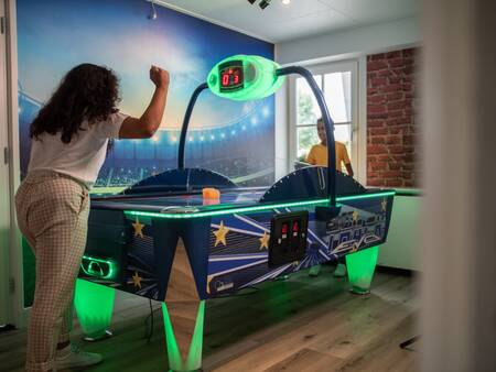 Im Spielzimmer des Topparken Recreatiepark het Esmeer wird Airhockey gespielt