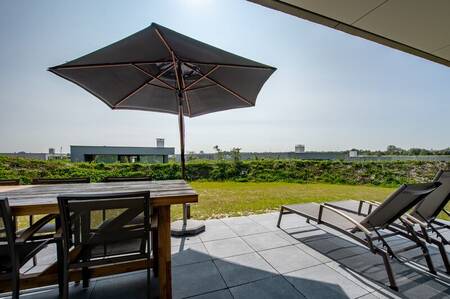 Garten mit Terrasse und Sonnenliegen einer Luxusvilla bei Z'andvillas De Groote Duynen